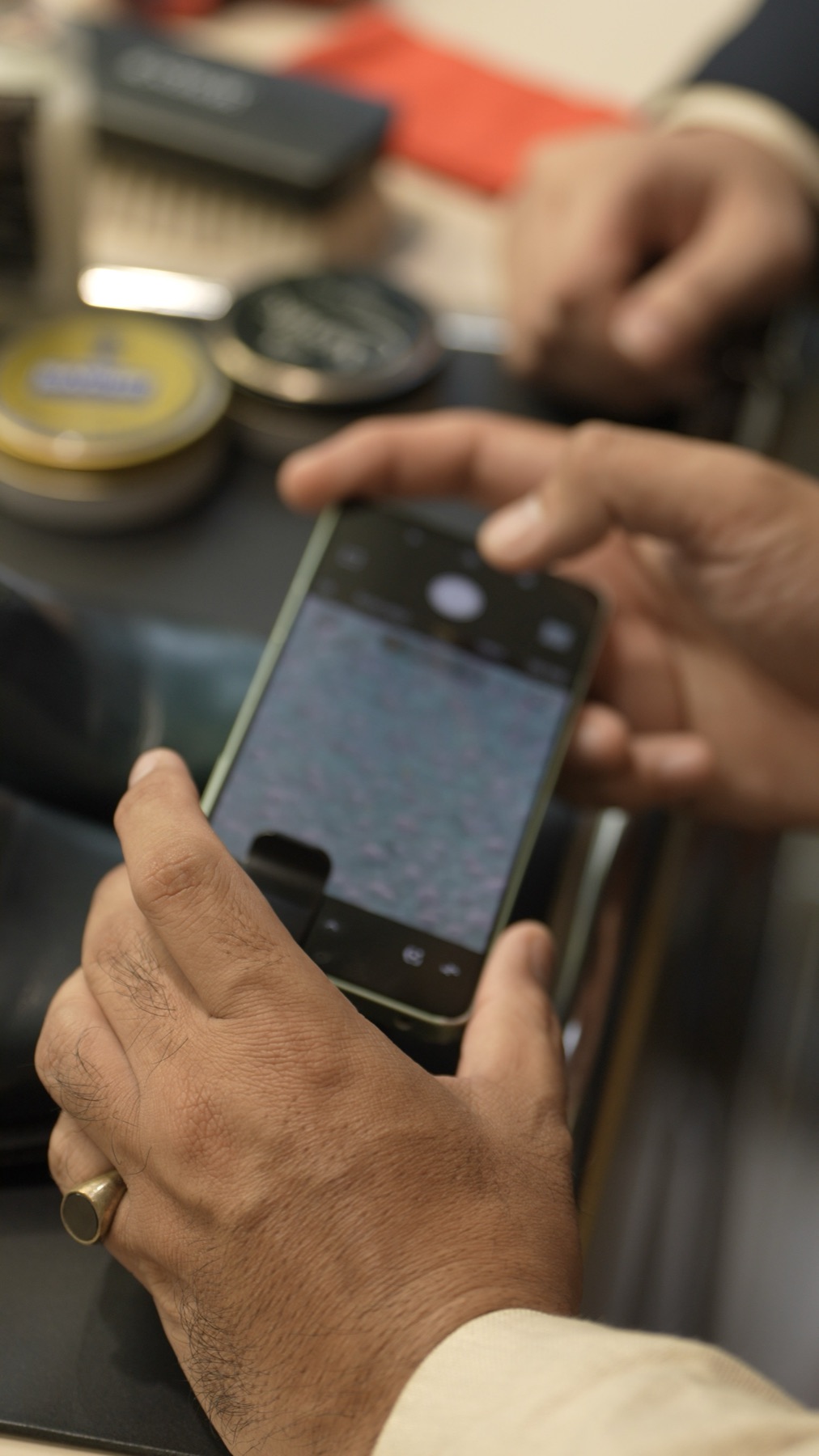 The leather surface magnified on a phone connected to a microscope